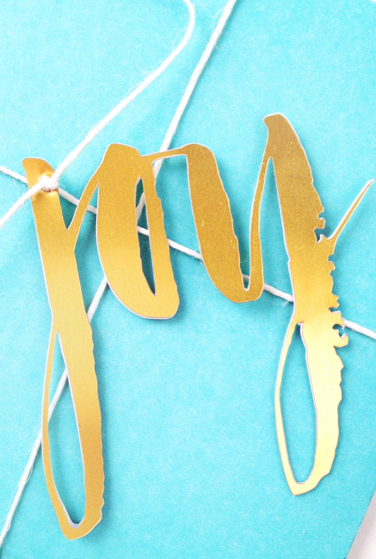 DIY Brushy Embellishments - Maritza Lisa - Take your favorite brush or script front and make your own personalized gift toppers with gold foil. Click through for the tutorial!