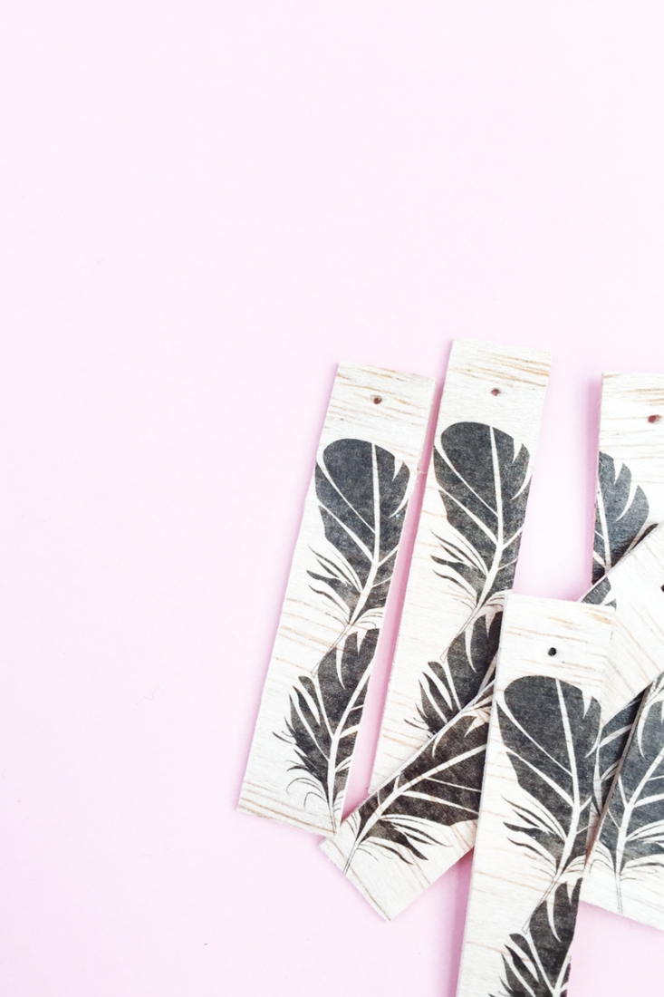 DIY Feather Wood Tags - Maritza Lisa: All you need is this free feather download, some balsa wood and printable tattoo paper to make these pretty tags. Click through for the tutorial....