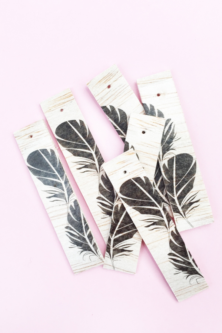 DIY Feather Wood Tags - Maritza Lisa: All you need is this free feather download, some balsa wood and printable tattoo paper to make these pretty tags. Click through for the tutorial....
