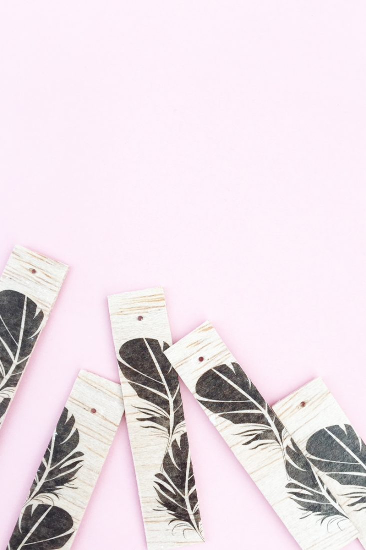 DIY Feather Wood Tags - Maritza Lisa: All you need is this free feather download, some balsa wood and printable tattoo paper to make these pretty tags. Click through for the tutorial....