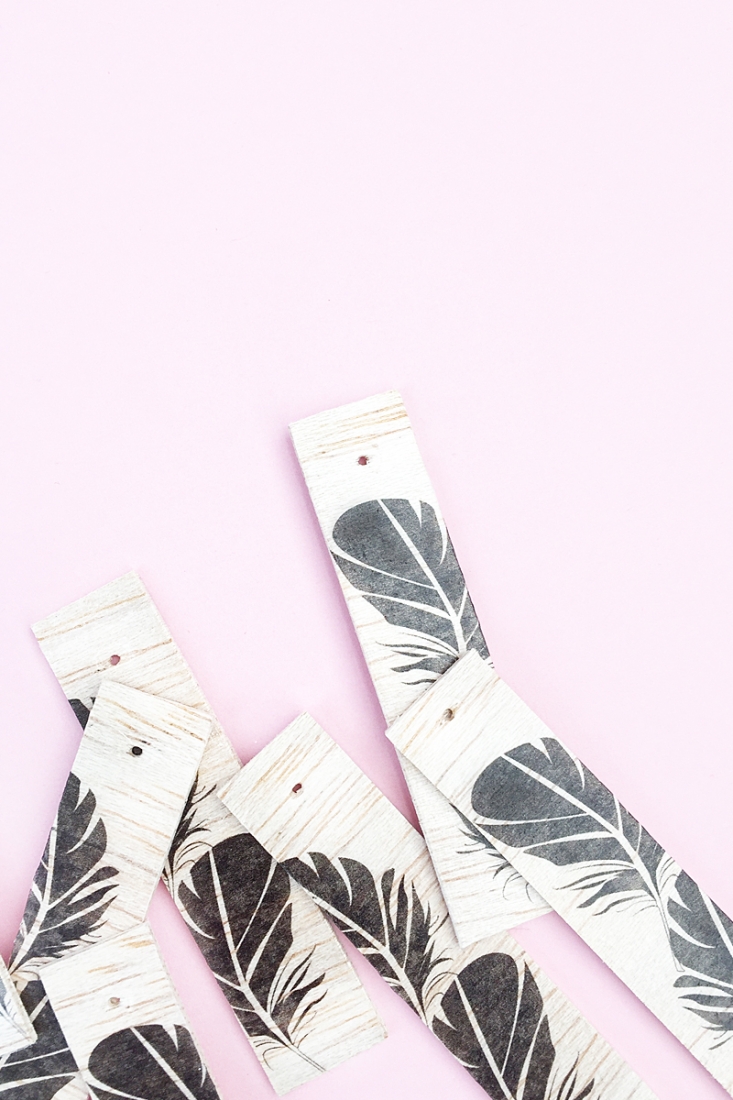 DIY Feather Wood Tags - Maritza Lisa: All you need is this free feather download, some balsa wood and printable tattoo paper to make these pretty tags. Click through for the tutorial....