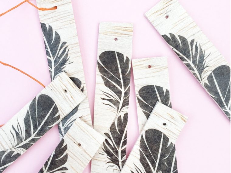 DIY Feather Wood Tags - Maritza Lisa: All you need is this free feather download, some balsa wood and printable tattoo paper to make these pretty tags. Click through for the tutorial....