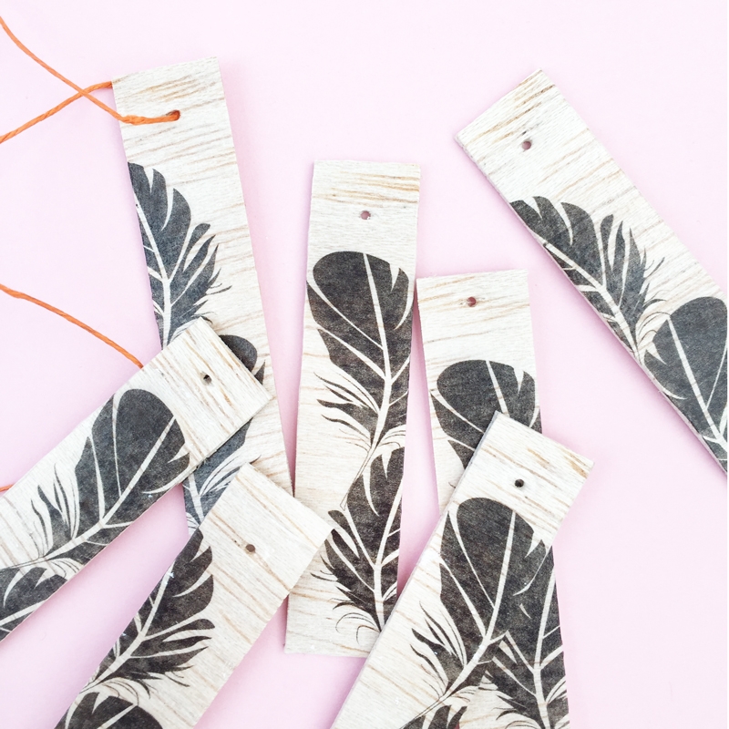 DIY Feather Wood Tags - Maritza Lisa: All you need is this free feather download, some balsa wood and printable tattoo paper to make these pretty tags. Click through for the tutorial....