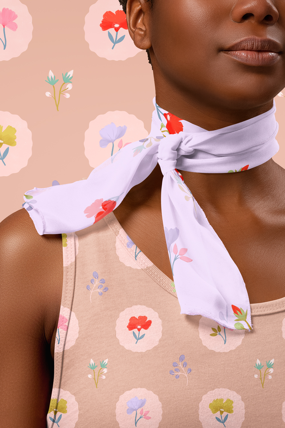 Feminine floral pattern applied to fashion fabric on a dress and scarf, featuring soft pastel blooms on a warm neutral base